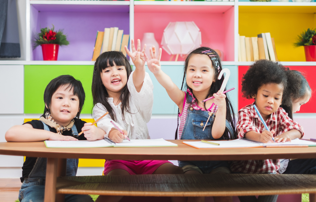 Group diversity kids studying at school, rising hands for answer